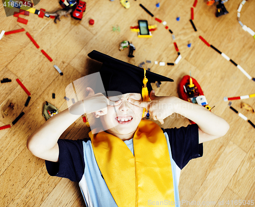 Image of little cute preschooler boy among toys lego at home education in