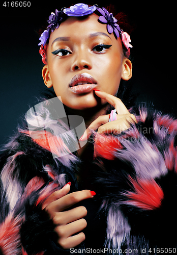 Image of young pretty african american woman in spotted fur coat and flow