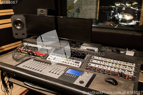 Image of music mixing console at sound recording studio