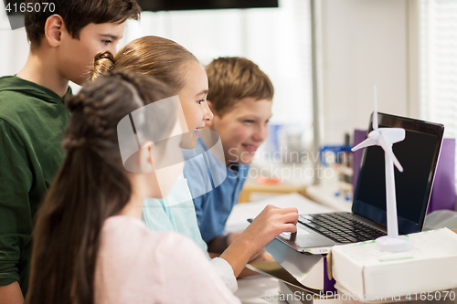 Image of children with laptop and wind turbine at school