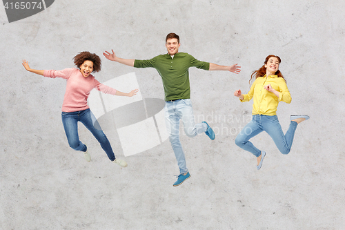 Image of smiling young man jumping in air