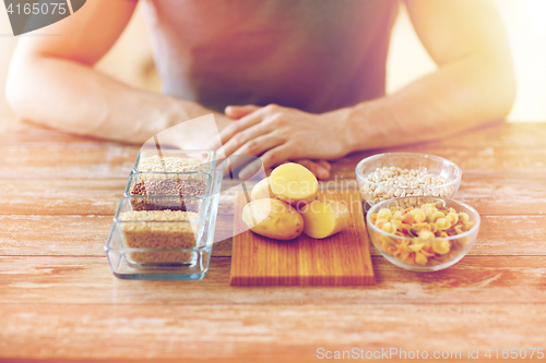 Image of close up of male hands with carbohydrate food