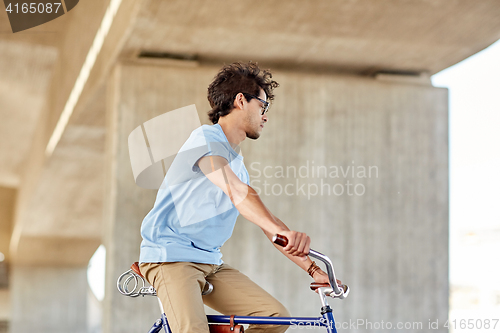 Image of  hipster man riding fixed gear bike