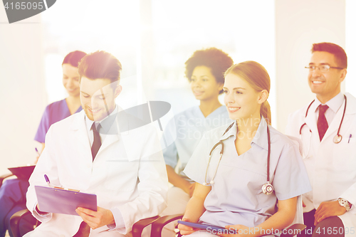 Image of group of happy doctors on seminar at hospital