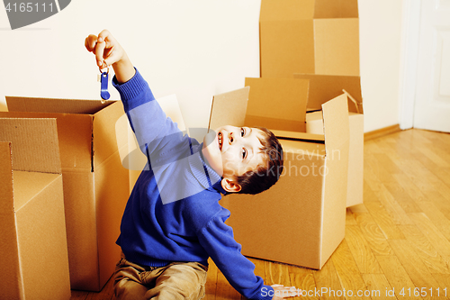 Image of little cute boy in empty room, remoove to new house. home alone, lifestyle people concept