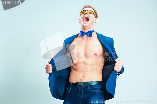 Image of The portrait of emotional fashion man with naked torso wearing butterfly tie