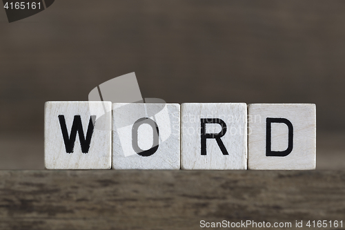 Image of Word, written in cubes on wooden background