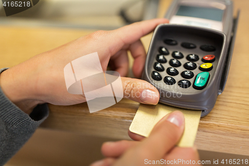 Image of close up of hand inserting bank card to terminal