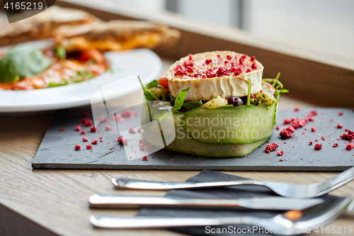 Image of goat cheese salad with vegetables at restaurant