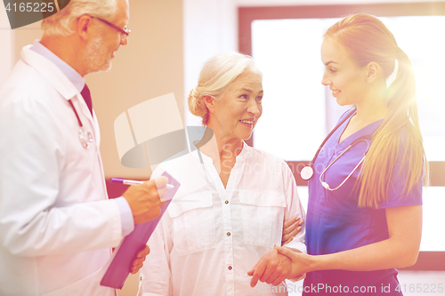 Image of medics and senior patient woman at hospital