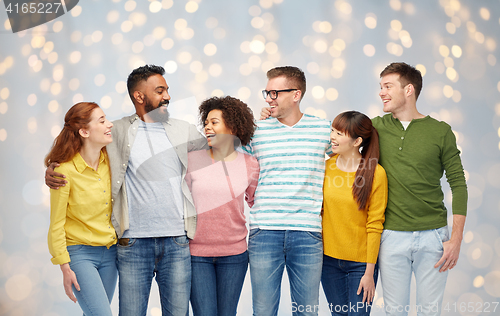 Image of international group of happy people over lights