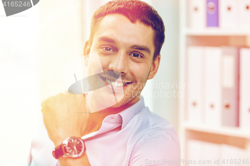 Image of portrait of smiling businessman in office