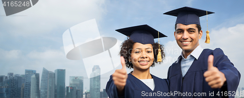 Image of students or bachelors showing thumbs up over city