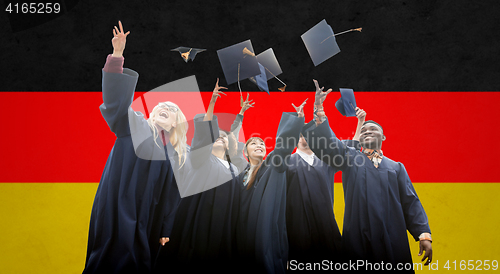 Image of happy students throwing mortarboards up