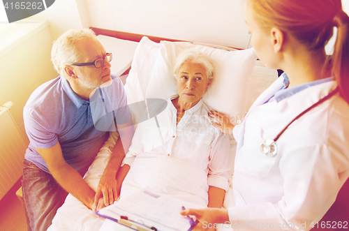 Image of senior woman and doctor with clipboard at hospital