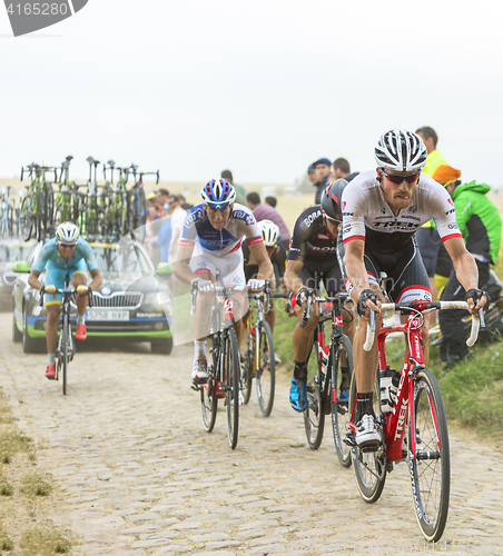 Image of The Peloton on a Cobblestone Road - Tour de France 2015