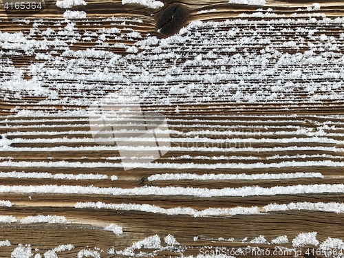 Image of old wood covered with snow background