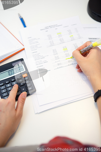 Image of Young woman working with papers