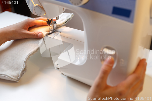 Image of Photo of girl with sewing-machine