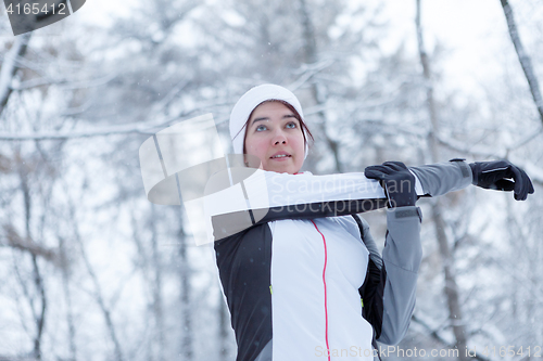 Image of Winter girl on stretching exercises