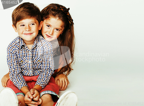 Image of little cute boy and girl hugging playing on white background, ha