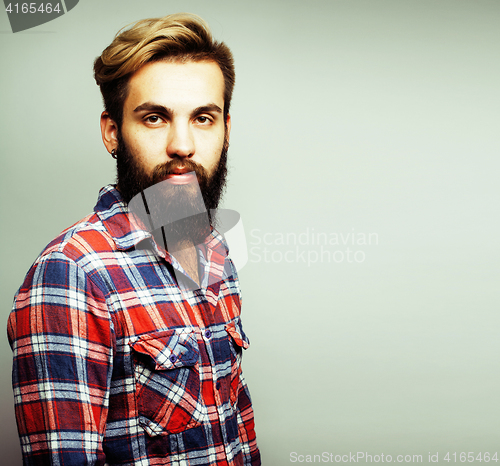 Image of portrait of young bearded hipster guy smiling on white backgroun