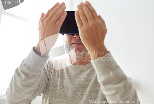 Image of old man in virtual reality headset or 3d glasses