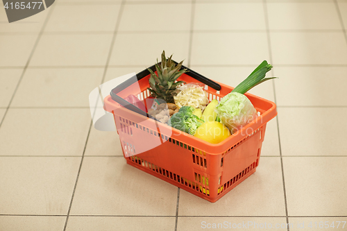 Image of food basket on grocery or supermarket floor