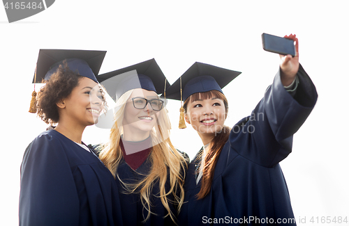 Image of students or bachelors taking selfie by smartphone