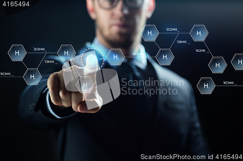 Image of close up of scientist and virtual chemical formula