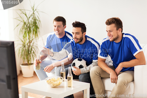 Image of friends or football fans watching soccer at home