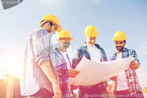 Image of group of builders with tablet pc and blueprint