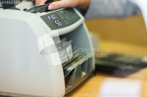 Image of dollars in electronic money counter at bank office