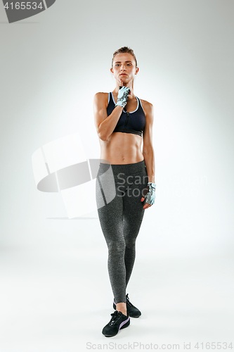 Image of Muscular young woman athlete on white