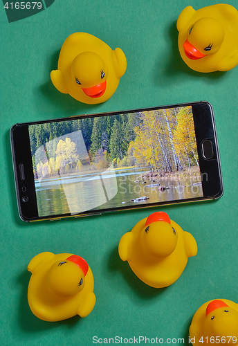 Image of Yellow rubber duck and smartphone concept