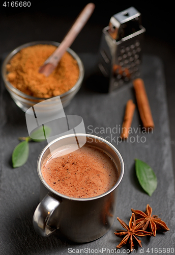 Image of Cup of hot chocolate, cinnamon sticks