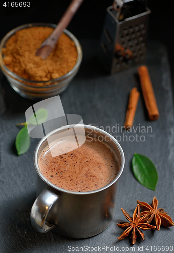 Image of Cup of hot chocolate, cinnamon sticks