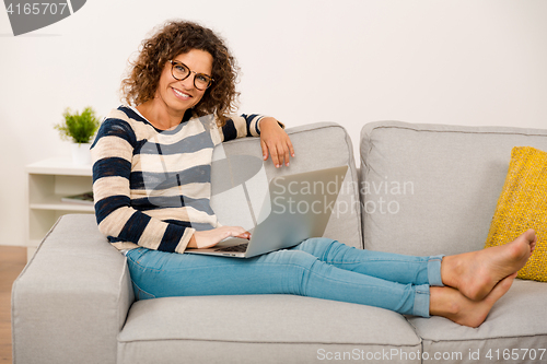 Image of Beautiful woman working at home