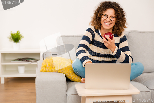 Image of Beautiful woman working at home