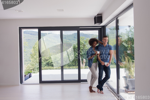Image of romantic happy young couple relax at modern home indoors