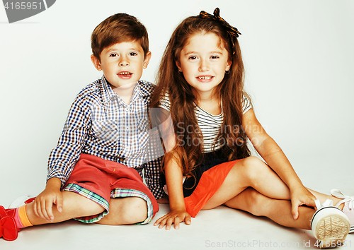 Image of little cute boy and girl hugging playing on white background, ha