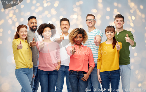 Image of international group of people showing thumbs up