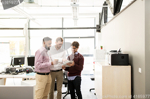 Image of business team with tablet pc and coffee at office