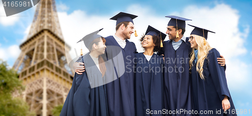 Image of happy students or bachelors over eiffel tower