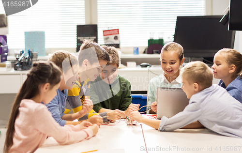 Image of happy children with laptop at robotics school