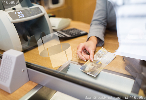 Image of clerk with swiss francs cash money at bank office