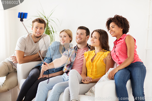 Image of happy friends taking selfie by smartphone at home