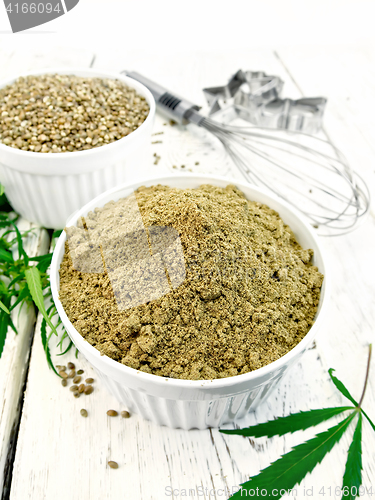 Image of Flour hemp and grain in bowls with leaf on board