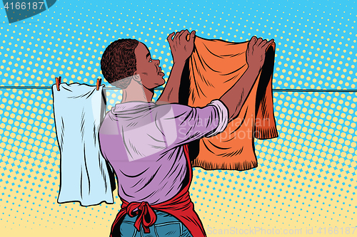 Image of Vintage employee hangs up to dry clothes