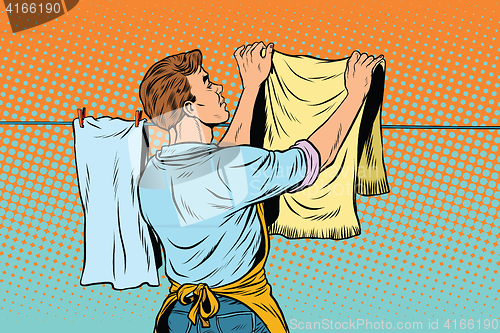 Image of Vintage employee hangs up to dry clothes
